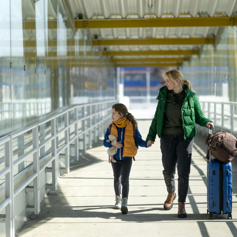 Starting Your TUI Holiday Family walking through an airport with luggage ready for their holiday