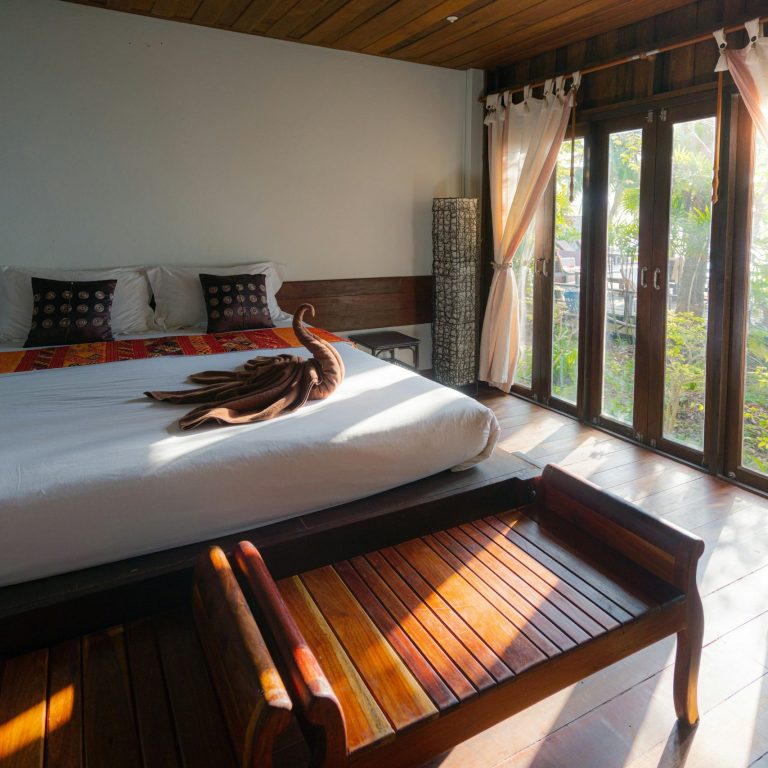Checking Hotel Room Details hotel room with bed, seating area and large windows
